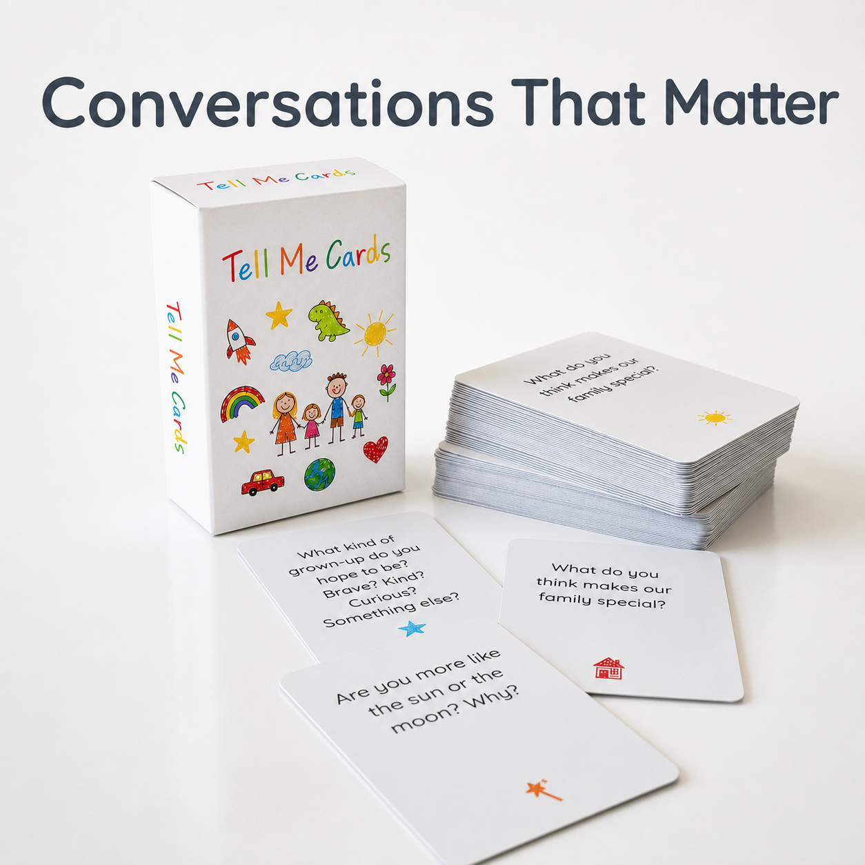 The 'Tell Me Cards' deck and packaging shown on a clean white background, with the title 'Conversations That Matter' printed at the top. The white box features colorful illustrations of children, a rainbow, a rocket, and a car, while several sample cards are fanned out in front showing printed prompts.
