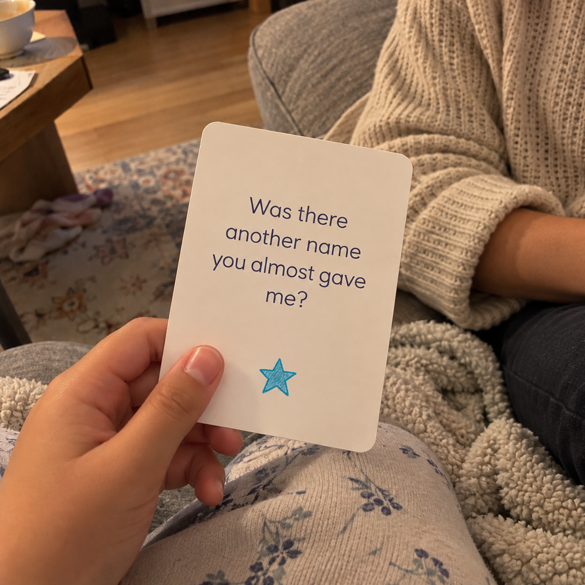 A child holding an About Me card that reads: Was there another name you almost gave me?