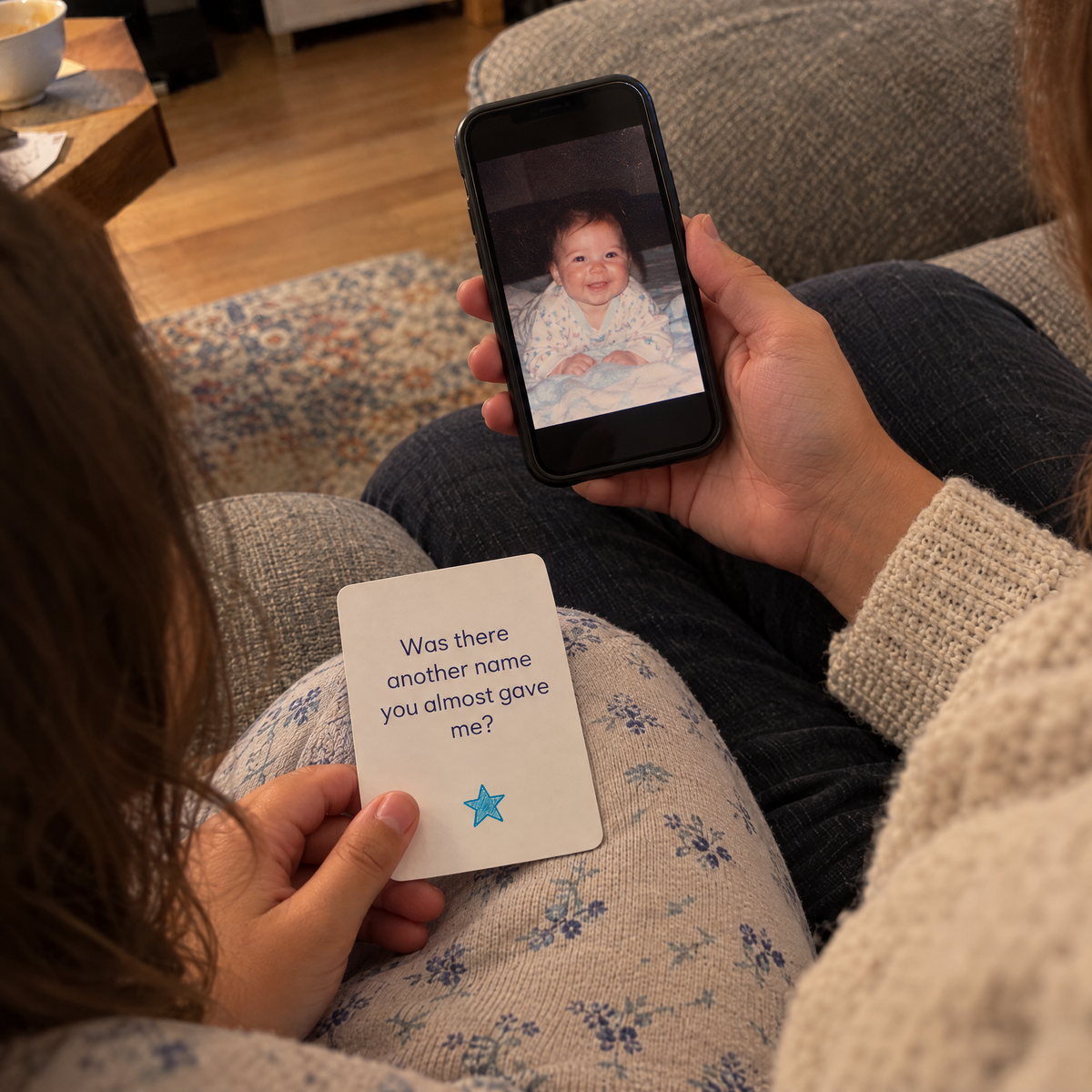 Parent showing their child a baby photo while the child holds an About Me card