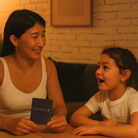 Mother and daughter sharing a Tell Me Cards conversation card, daughter reacting with excitement