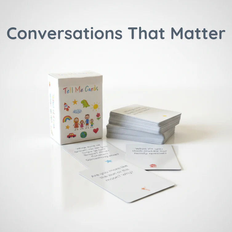 Tell Me Cards 107-card conversation deck box with a stack of cards and three sample question cards displayed on a white background