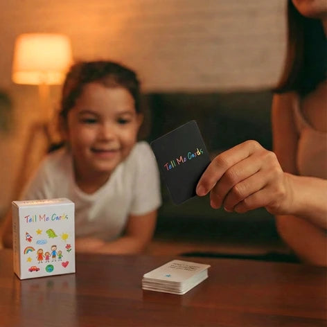 Young child smiling as her mother shows her a Tell Me Cards conversation card